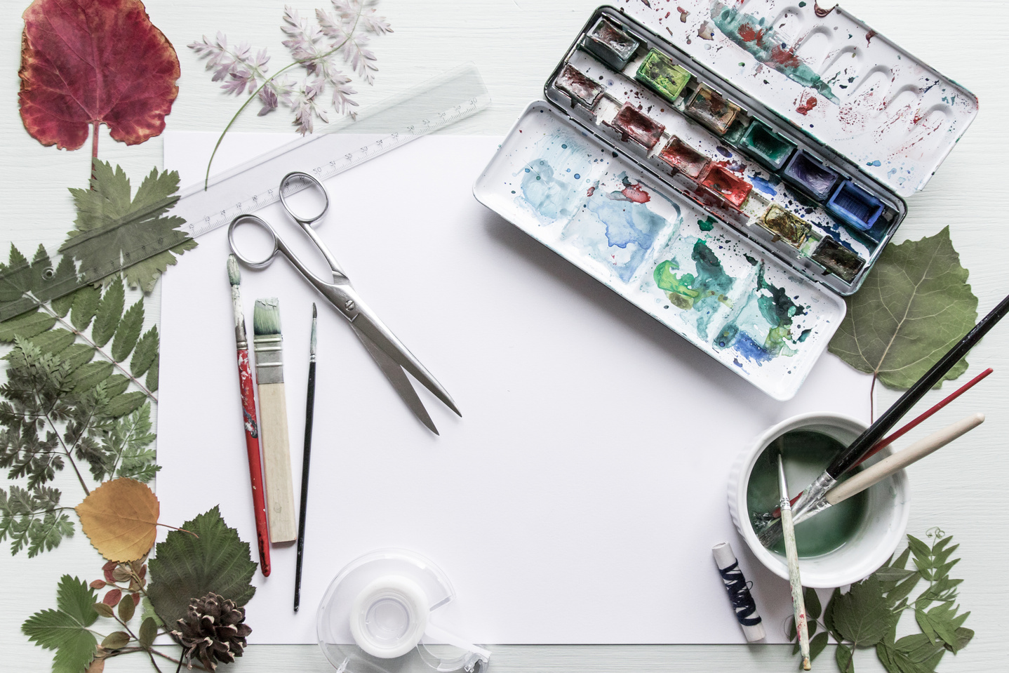 Artist studio workdesk with art and craft equipment seen from above